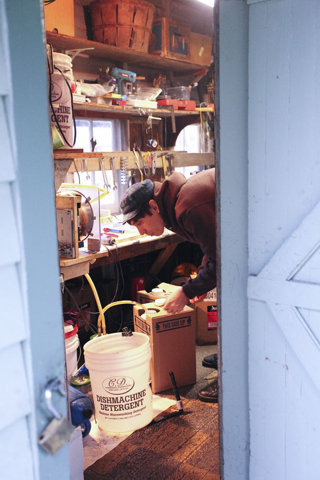 Santi working in his workshop, seen through the doorway
