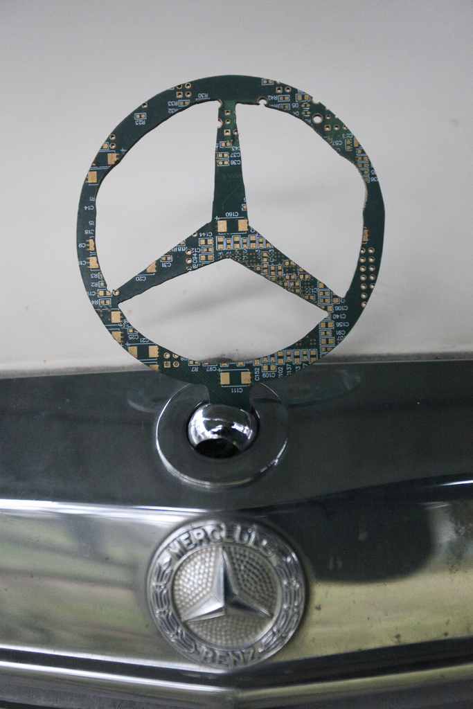 A Mercedes star hood ornament cut from a circuit board